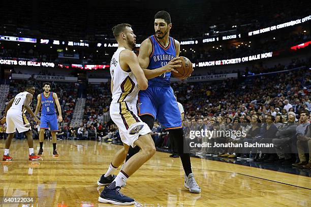 Enes Kanter of the Oklahoma City Thunder drives against Donatas Motiejunas of the New Orleans Pelicans during the second half of a game at the...