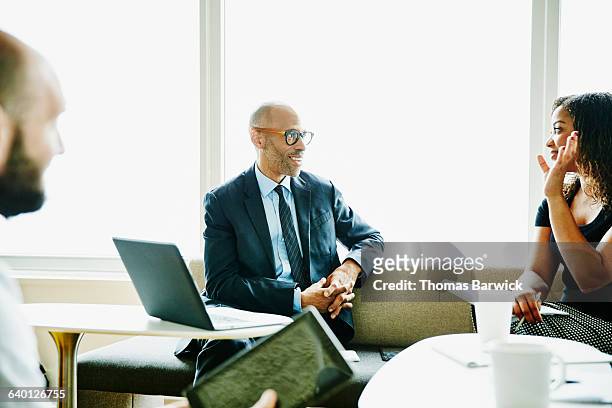 mature businessman leading meeting in office - mature business woman digital tablet corporate professional stockfoto's en -beelden