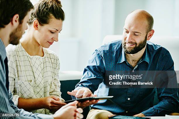 businessman discussing project on digital tablet - business casual stock pictures, royalty-free photos & images