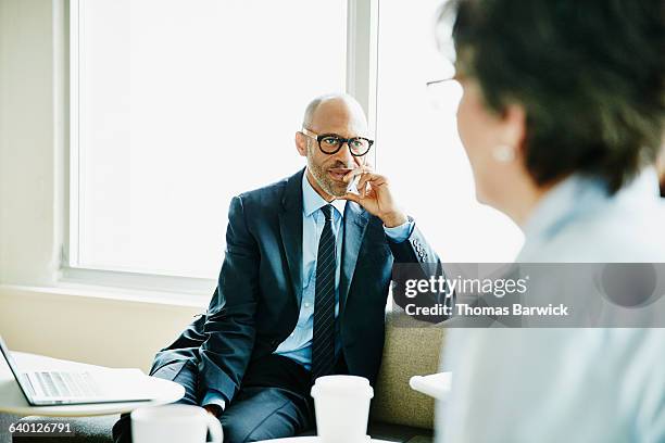 mature business executive listening during meeting - dedication background stock pictures, royalty-free photos & images
