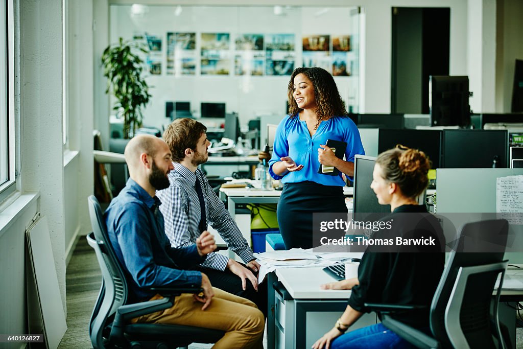 Businesswoman leading meeting with colleagues