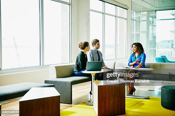 businesswoman leading meeting with colleagues - three people office stock pictures, royalty-free photos & images