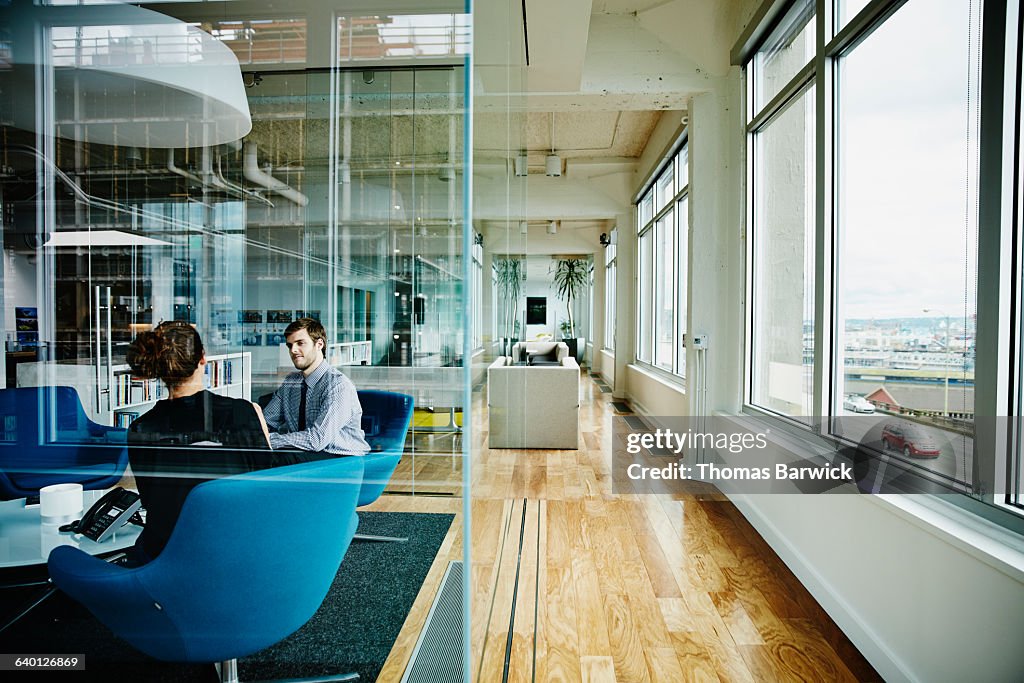 Businessman and businesswoman discussing project