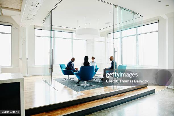businesspeople discussing project in office - blue corporate imagens e fotografias de stock