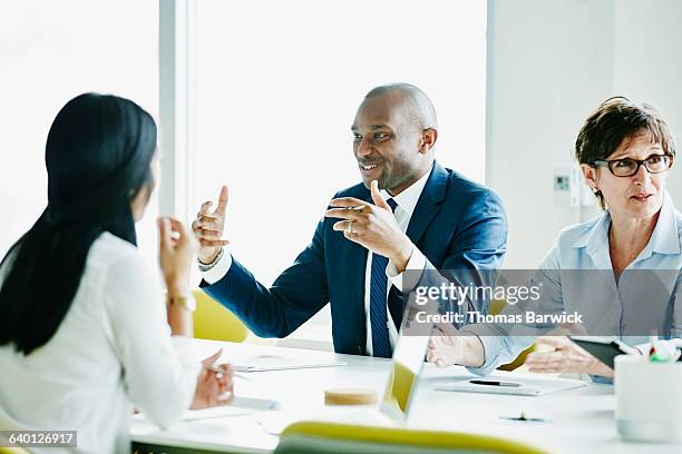 businessman in discussion with colleagues - corporate modern office bright diverse stock pictures, royalty-free photos & images