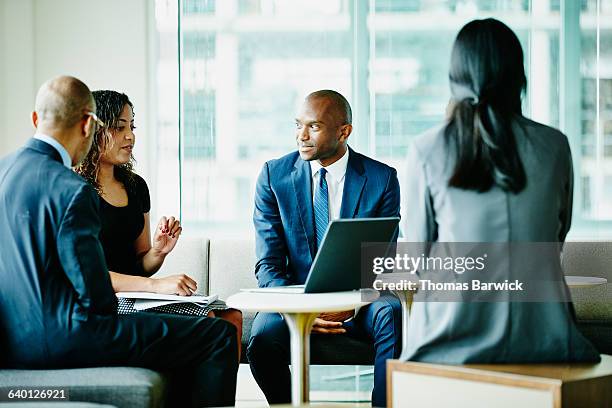 businesswoman leading discussion during meeting - business relationship management stock pictures, royalty-free photos & images