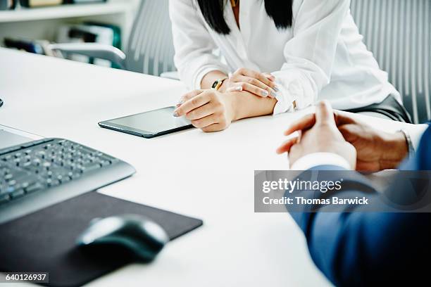 businessman and businesswoman working on project - computer mouse table stock-fotos und bilder