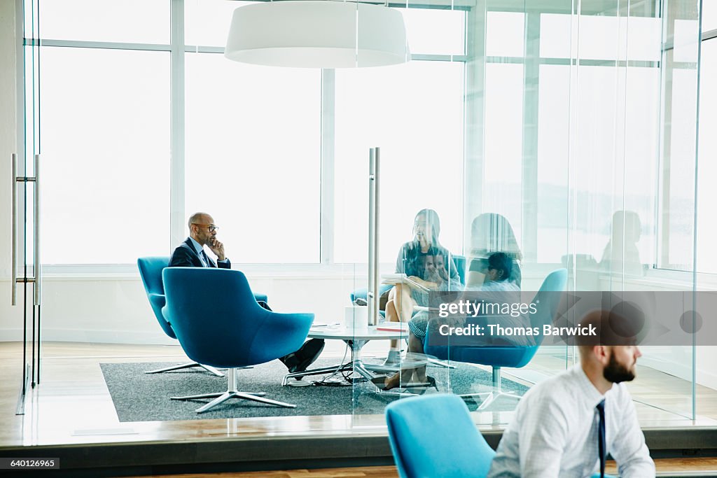 Business executive listening during meeting