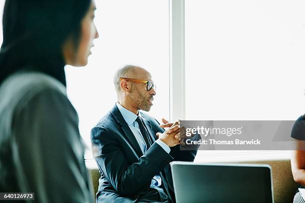 businessman discussing project with colleague - corporate modern office bright diverse stock pictures, royalty-free photos & images