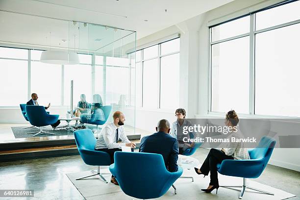 businesspeople in meeting in office - corporate modern office bright diverse stock pictures, royalty-free photos & images