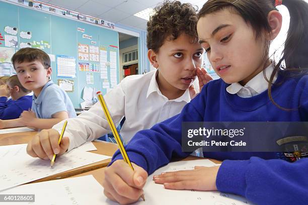 children cheating during test in classroom - girl white background stock pictures, royalty-free photos & images