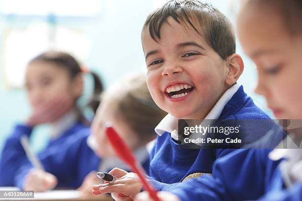 happy boy in class at school - allievo foto e immagini stock