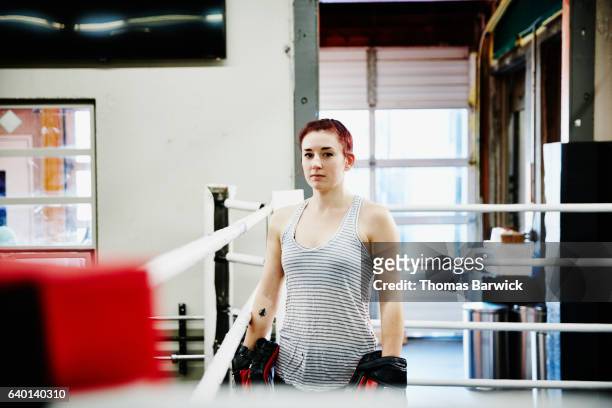 portrait of female fighter in ring in gym - mixed martial arts fotografías e imágenes de stock