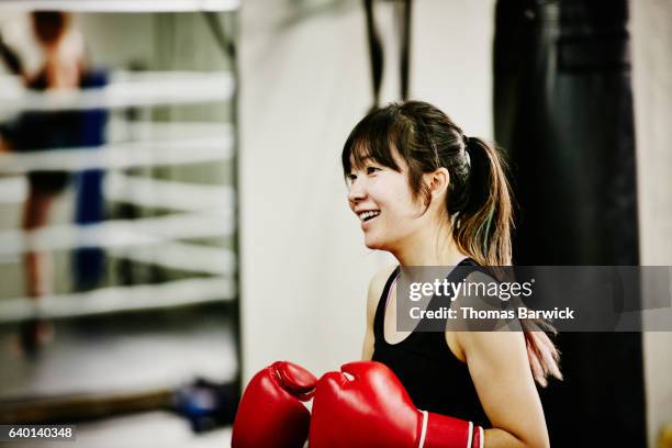 smiling female kickboxer working out in fighting gym - practice stock pictures, royalty-free photos & images