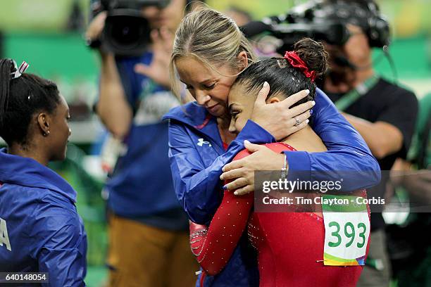 Gymnastics - Olympics: Day 10 Coach Maggie Haney congratulates Lauren Hernandez of the United States after performing her routine which won her the...