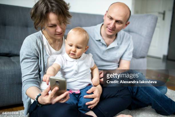 family taking selfies at home - alexandra iakovleva stockfoto's en -beelden