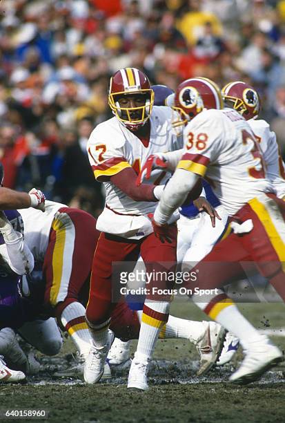 Washington, D.C. Doug Williams of the Washington Redskins hands off to George Rogers against the Minnesota Vikings during the NFC Championship Game...