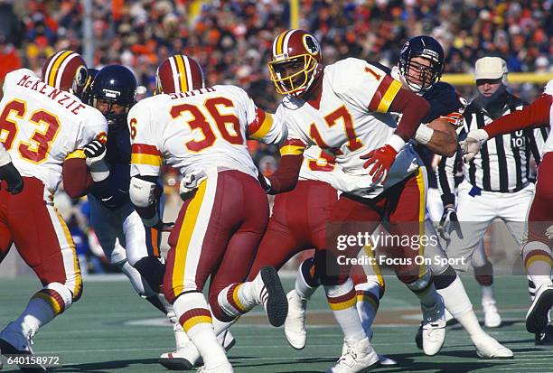 Doug Williams of the Washington Redskins hands off to Timmy Smith against the Chicago Bears during the NFC Divisional Playoff Game January 10, 1988...