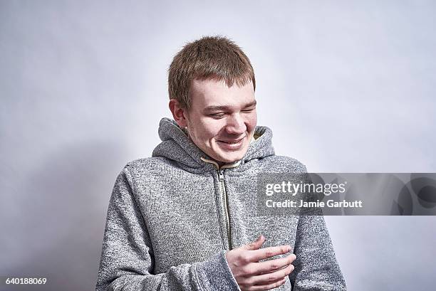 blind british teenager laughing looking to side - blindness stock-fotos und bilder