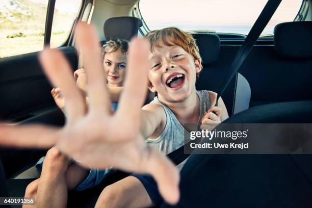 boy and girl on rear seat of car - backseat bildbanksfoton och bilder