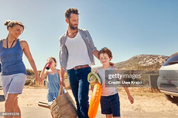 a family on their way to the beach - four people in car fotografías e imágenes de stock