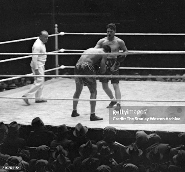 Gene Tunney squares up with Jack Dempsey as referee Tommy Reilly watches, at Sesquicentennial Stadium, Philadelphia, Pennsylvania, September 23,...