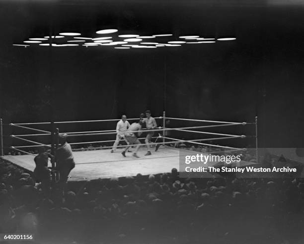 Gene Tunney squares up with Jack Dempsey as referee Tommy Reilly watches, at Sesquicentennial Stadium, Philadelphia, Pennsylvania, September 23,...