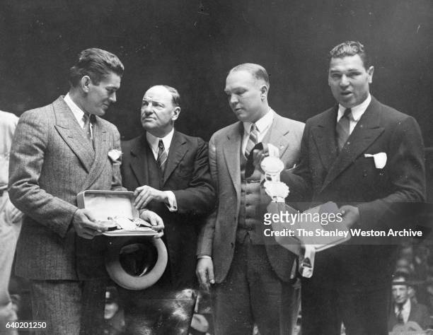 Heavyweight Champion Gene Tunney and the man he won the title from, Jack Dempsey receive their Championship Belts from the Boxers Writer's...