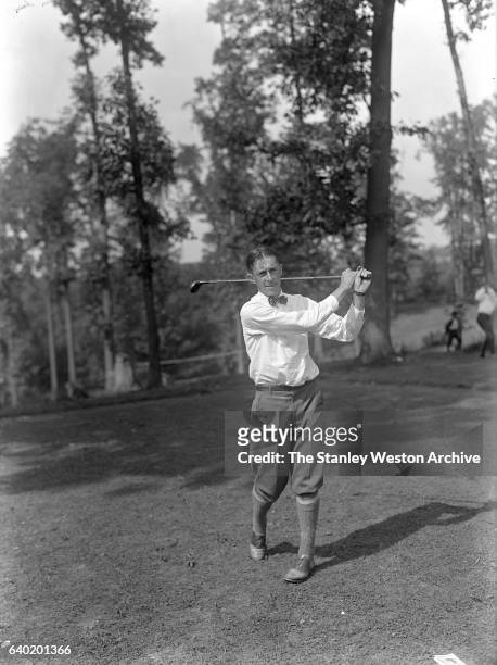 Francis DeSales Ouimet frequently referred to as the "father of amateur golf" takes a swing with his driver, circa 1900.
