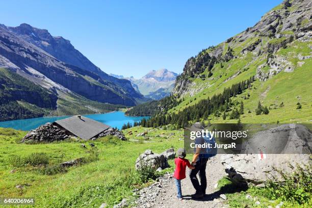 family hiking in the swiss mountains - alpine chalet stock pictures, royalty-free photos & images