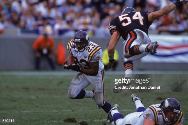 Michael Bennet of the Minnesota Vikings runs with the ball as teammate Matt Birk tries to block Brain Urlacher of the Chicago Bears during the game...