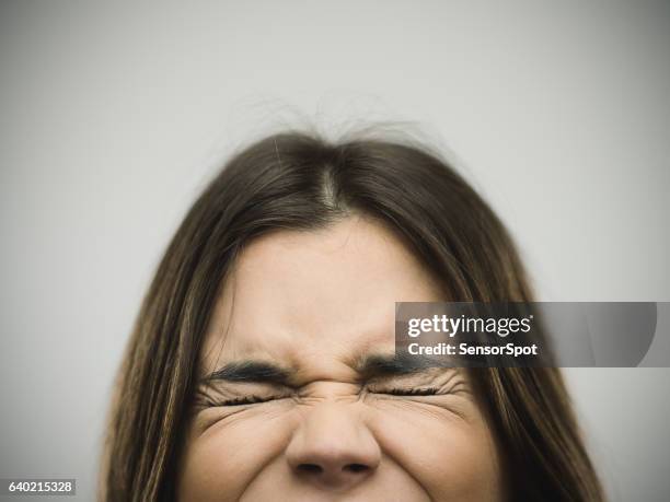 angry young woman clenching eyes - grimacing stock pictures, royalty-free photos & images