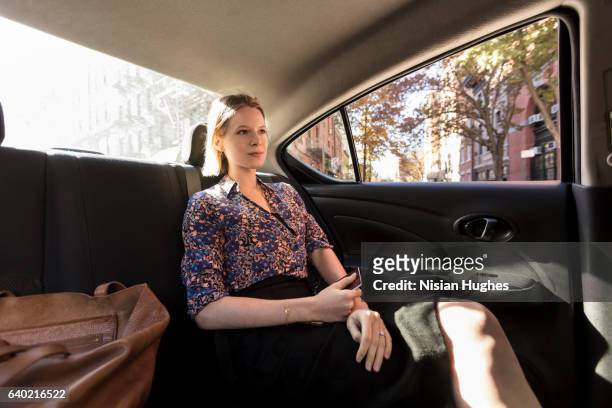 woman sitting in car - car back seat stock pictures, royalty-free photos & images