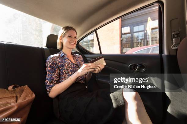 woman sitting in car - businesswoman nyc stockfoto's en -beelden