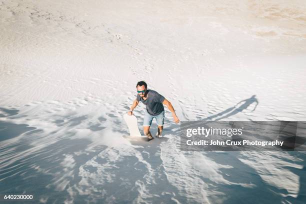 sand boarder - sand boarding stock pictures, royalty-free photos & images