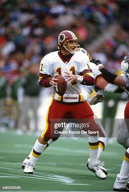 Mark Rypien of the Washington Redskins drops back to pass against the Philadelphia Eagles during an NFL football game December 22, 1991 at Veterans...