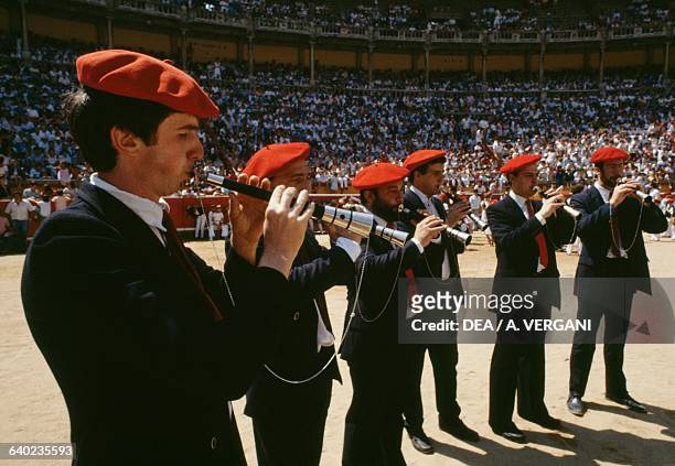 Flute players in traditional costumes in the bullring of Pamplona, San Fermin festival, Navarra, Spain.