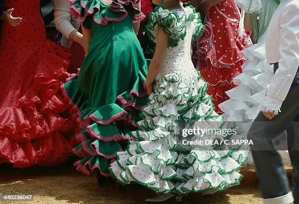 Women in traditional costumes during the Seville April fair, Andalusia, Spain.