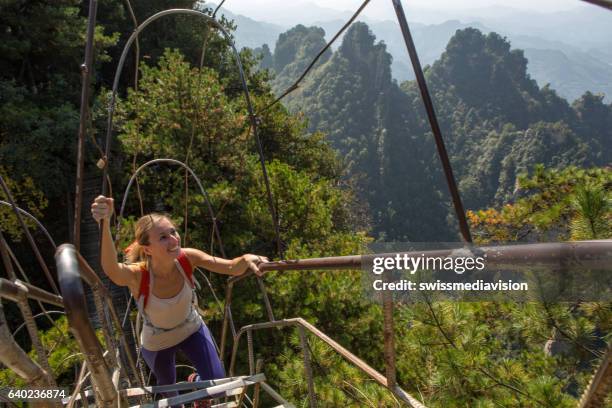 young woman hiker climbing to the top - quartz sandstone stock pictures, royalty-free photos & images