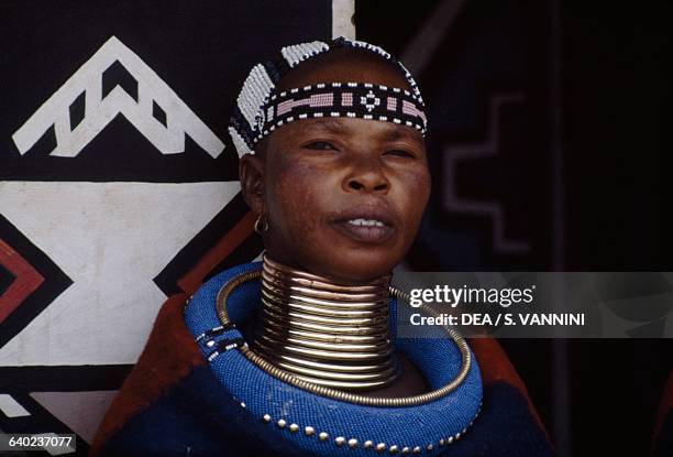 Ndebele woman wearing a traditional costume and idzilla, bronze or copper neck rings, South Africa.