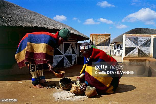 Ndebele woman preparing colours for painting murals in the village, Botshabelo township, Transvaal, South Africa.