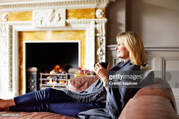 staying warm with a fire and a cup of tea - english tea room stock pictures, royalty-free photos & images