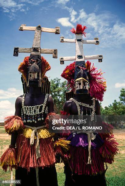 Dogon dancers wearing Kanaga masks performing the Dama or masked funeral dance, Bandiagara Escarpment, Mali.
