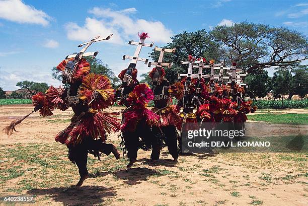 Dogon dancers wearing Kanaga masks performing the Dama or masked funeral dance, Bandiagara Escarpment, Mali.
