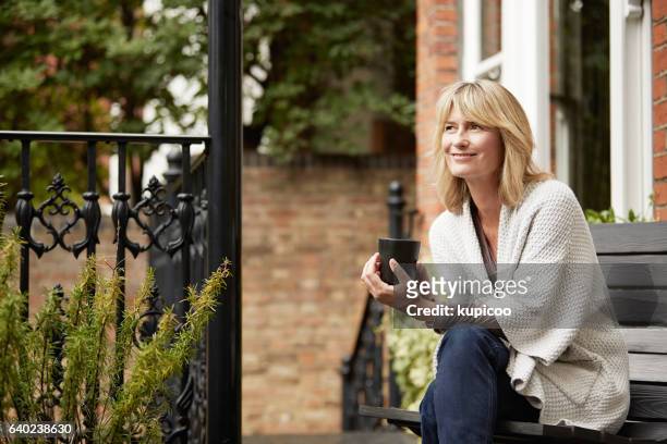 relaxing into the day with a cup of coffee - middle aged woman at home stock pictures, royalty-free photos & images