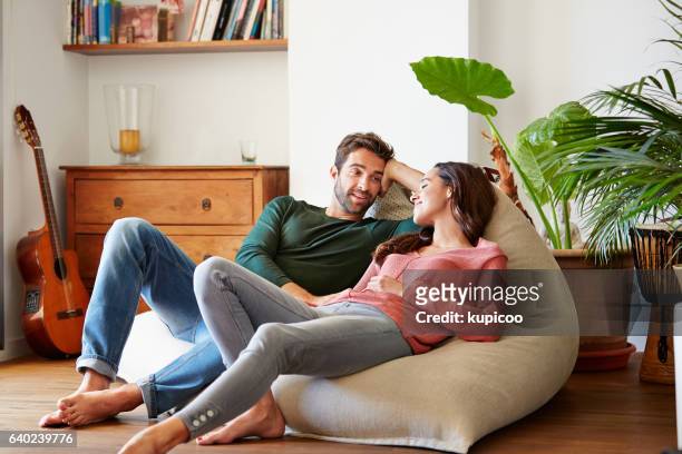 spending the day chilling together - sitting on couch imagens e fotografias de stock