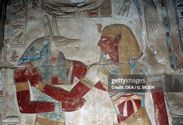 Painted relief depicting the Pharaoh and god Anubis, chapel of Osiris, Temple of Seti I, 1306-1290 bC, Abydos, Egypt. Egyptian civilisation, New...