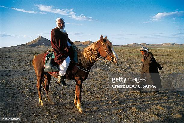 Tuareg man on horseback, Djebel Amour, Algeria.