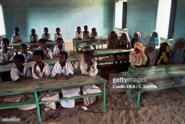 Children sitting at the desks in the village school, Sani, Bayuda desert, Sahara desert, Sudan.