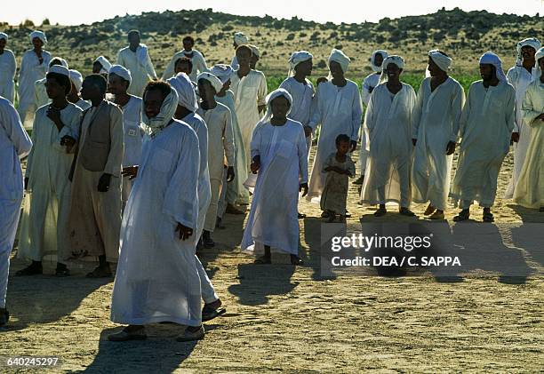 Group attending a wedding in white clothes, Kerma, Karmah, Nubia, Sudan.